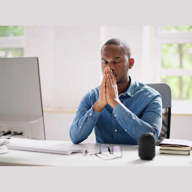 meditating employee at desk